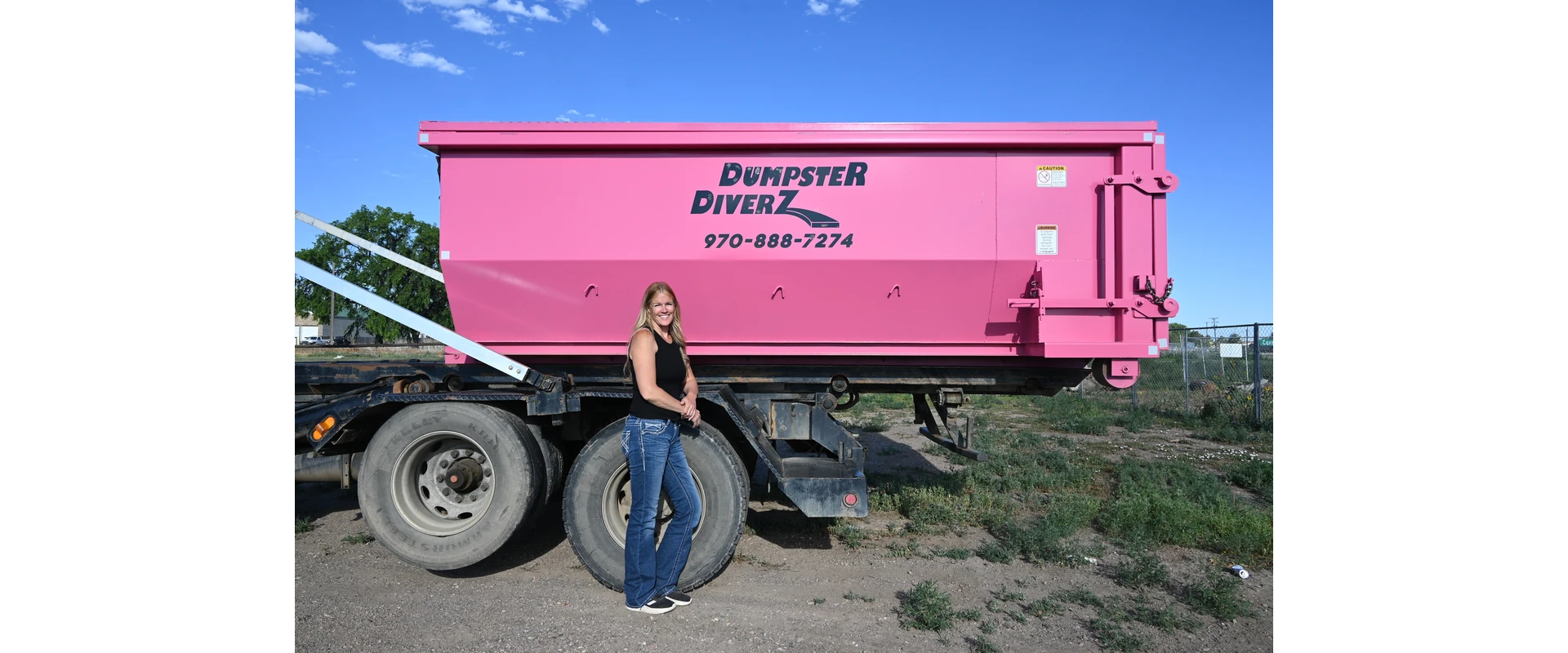 Dumpster Diverz pink garbage truck and bin curbside for residential trash pickup